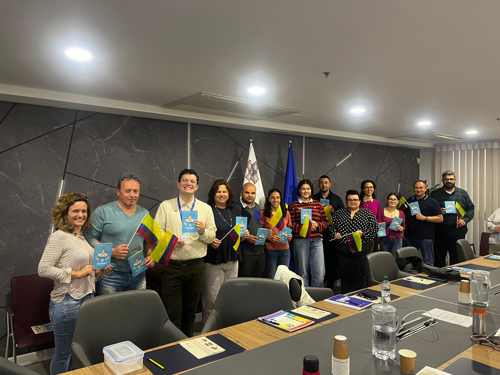 The two images show participants of groups 1 and 2 waving Colombian flags as part of the cultural track of this Spanish language training initiative by the Ministry of Foreign Affairs of Colombia in collaboration with the Office of the Deputy Prime Minister and Ministry of Foreign Affairs and Tourism of Malta, and the Institute for the Public Services, to mark 40 years of diplomatic relations. Participants are public officers; the trainer, generously provided by the government of Colombia, is Professor Jose Luis Duarte Rodríguez.